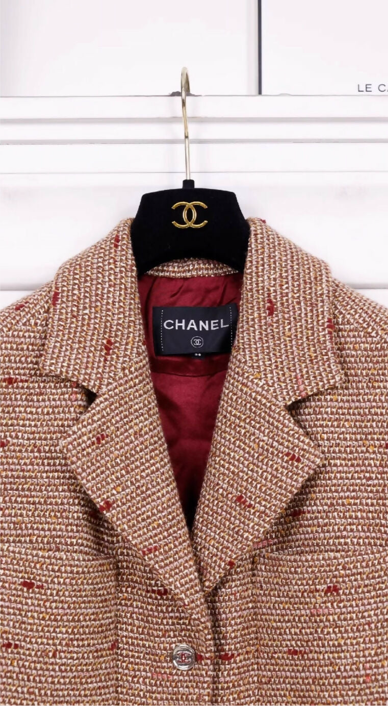 Chanel 23A Dakar Collection Show Style, the same style worn by Wang Yibo. Brown, two-pocket vest with heavy beaded trim.