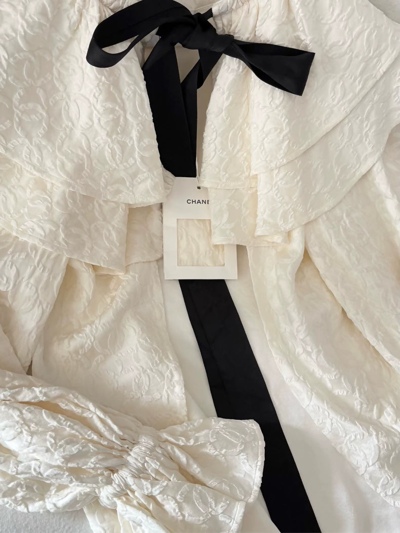 Chanel 25K ecru silk all-over logo bow cape cardigan