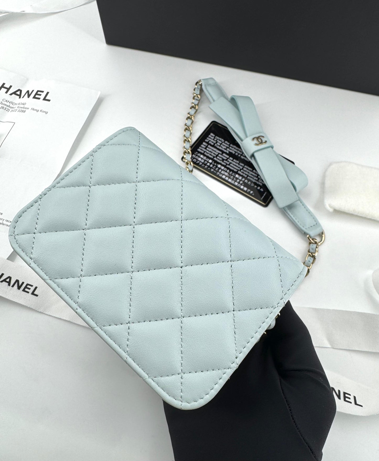 Chanel baby blue quilted leather coin purse with gold chain strap and a bow