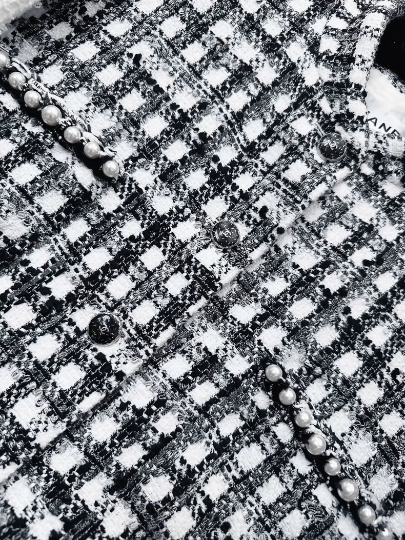 Chanel 25P black and white tweed jacket with pearl stitching