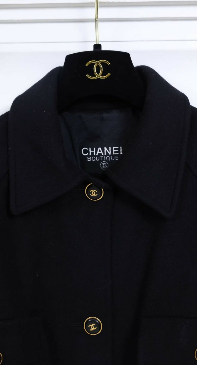 Chanel black woollen coat with black and gold buttons and four pockets.