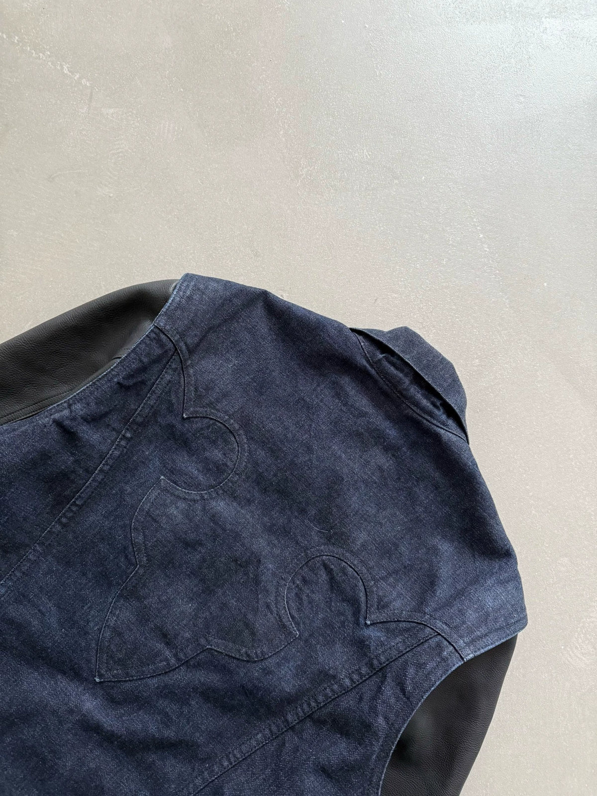 Chrome Hearts denim jacket with leather sleeves and a flame pattern on the back