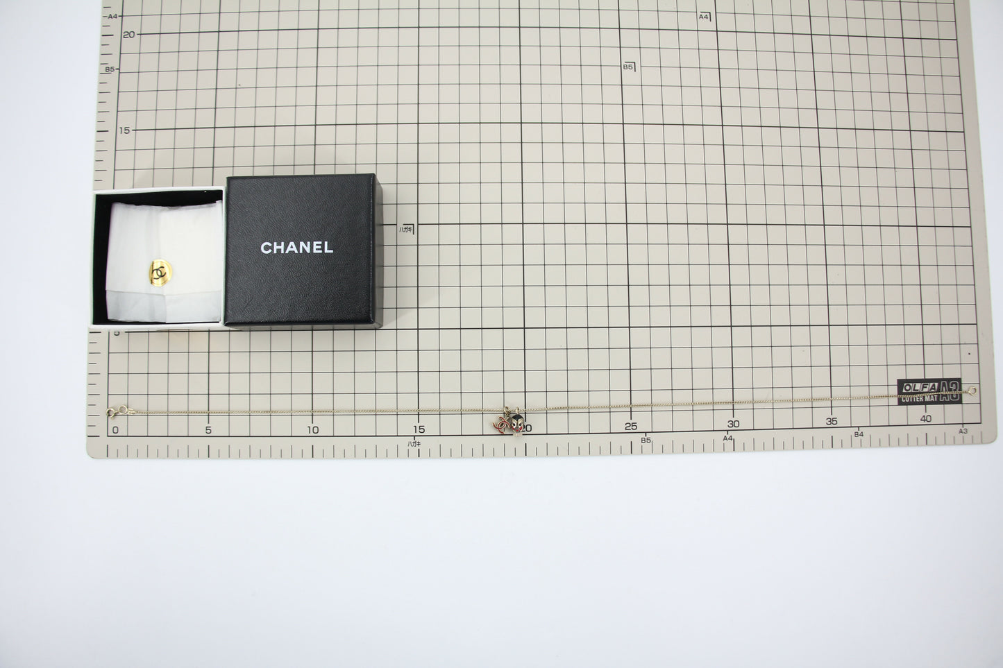 Chanel Vintage 05P Metal Doll Head & Red CC Necklace
