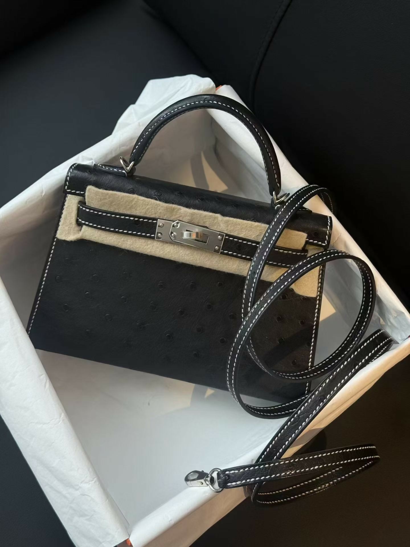 Hermès Mini Kelly 20 Noir Ostrich Leather with Contrast White Stitching and Palladium Hardware