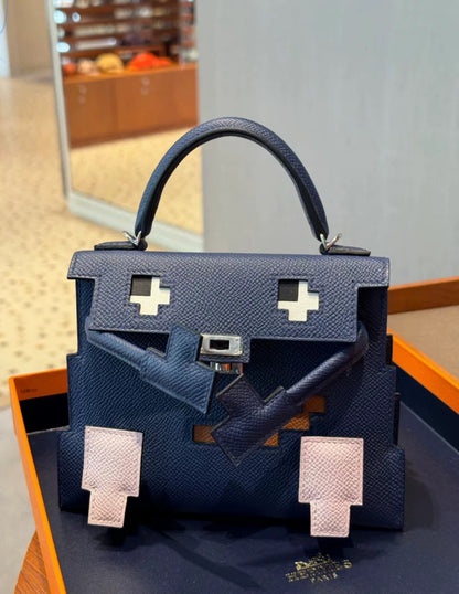 Limited Edition Hermès Kelly Doll Picto in Bleu Saphir, Mauve Pâle, Gold Epsom Leather 
Black Matte Alligator with Palladium Hardware