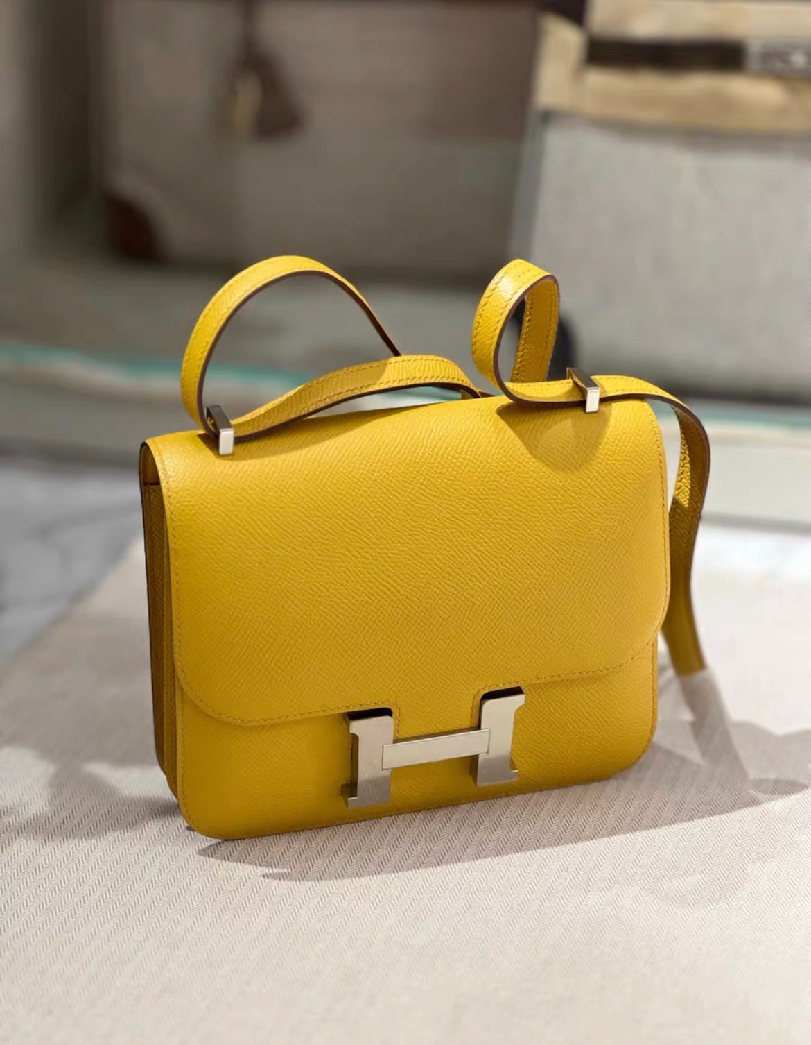 HERMÈS Constance Mini 19 shoulder bag in Jaune Ambre Epsom leather with Palladium hardware