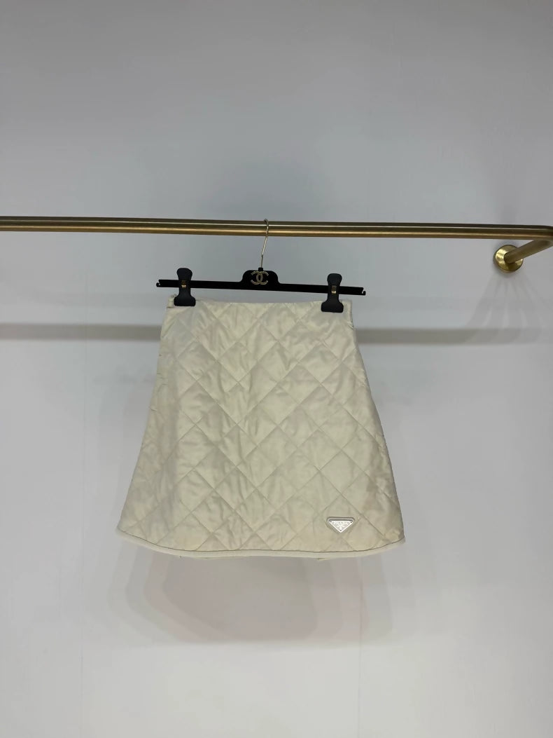 Prada 2025 skirt in cream white nylon with diamond pattern and triangular logo