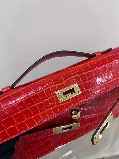Hermes Kelly cut red shiny crocodile leather gold hardware