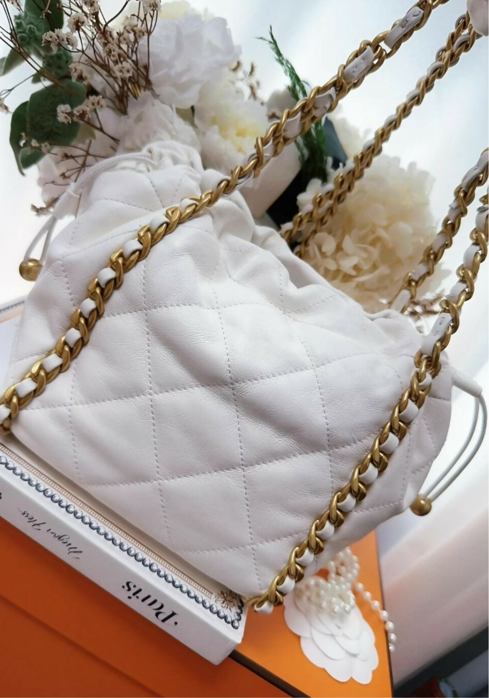 Chanel 22P ecru leather gold chain bucket bag