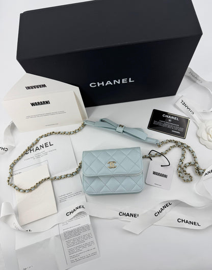 Chanel baby blue quilted leather coin purse with gold chain strap and a bow