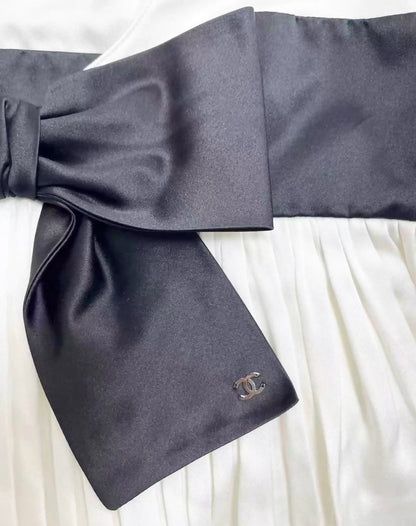 Chanel 25K black and white silk top with bow.