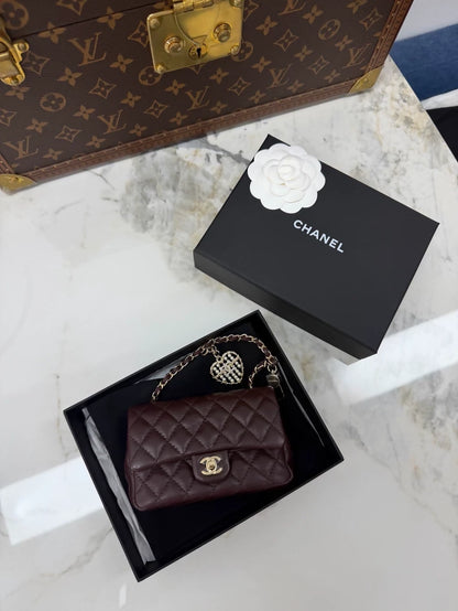 Chanel 25A heart-shaped rhinestone and pearl CF bag key charm.