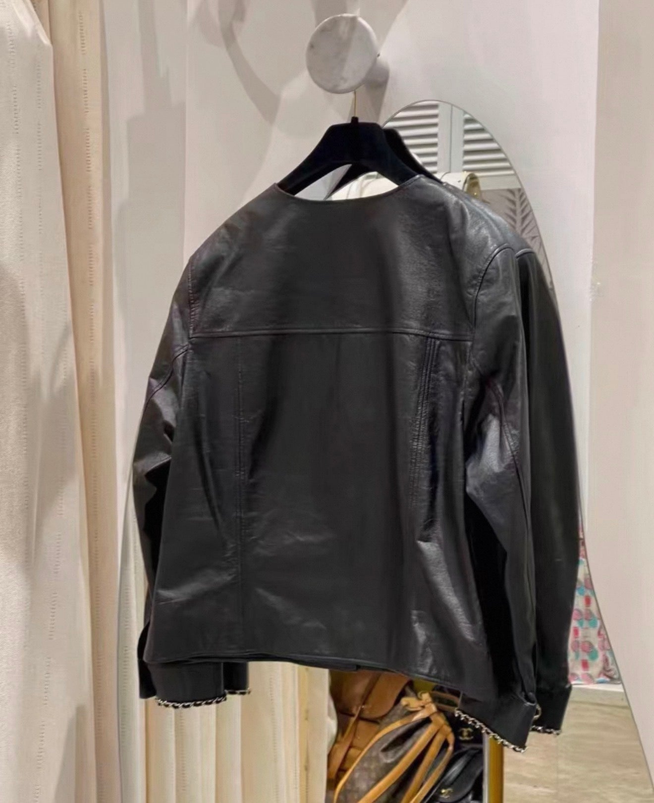 Chanel 24B black leather jacket with chain