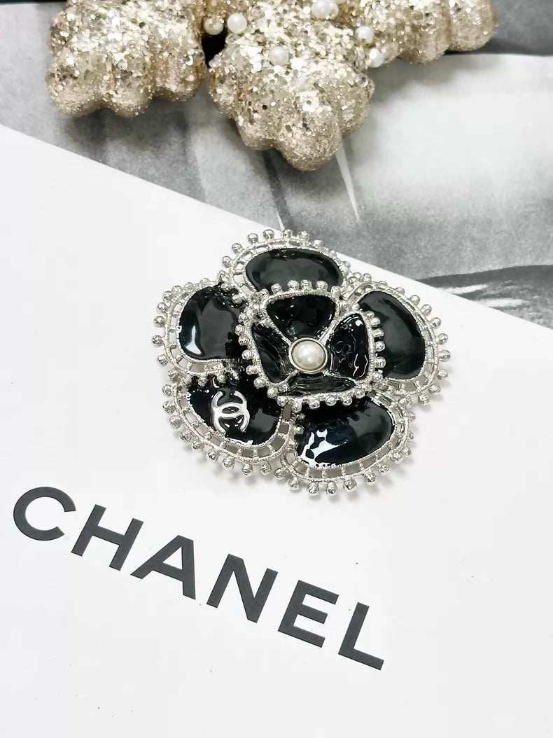 Chanel Fall/Winter 2023 black and silver pearl double C logo camellia brooch