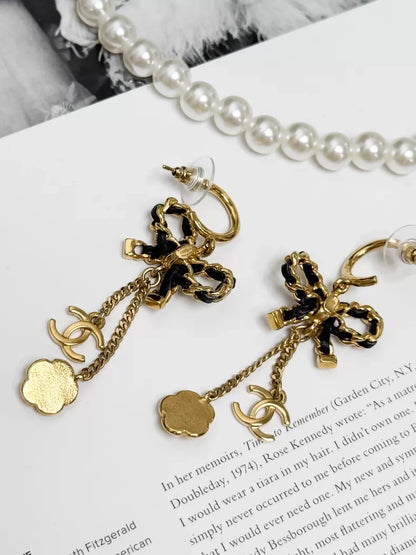 Chanel Métiers d'Art black and gold leather chain with bow earrings