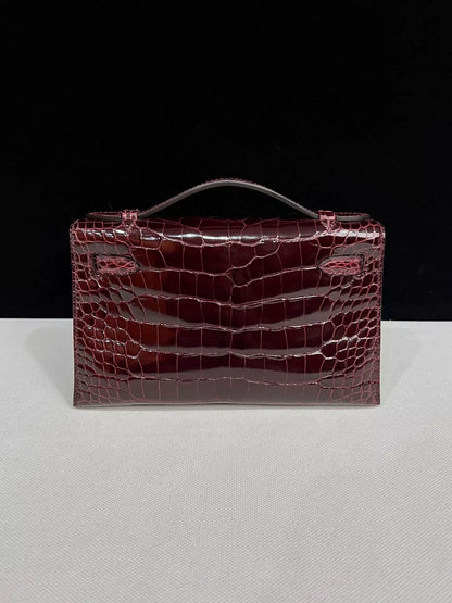 Hermes kelly Pochette Bordeaux Shiny Crocodile Leather Gold Hardware