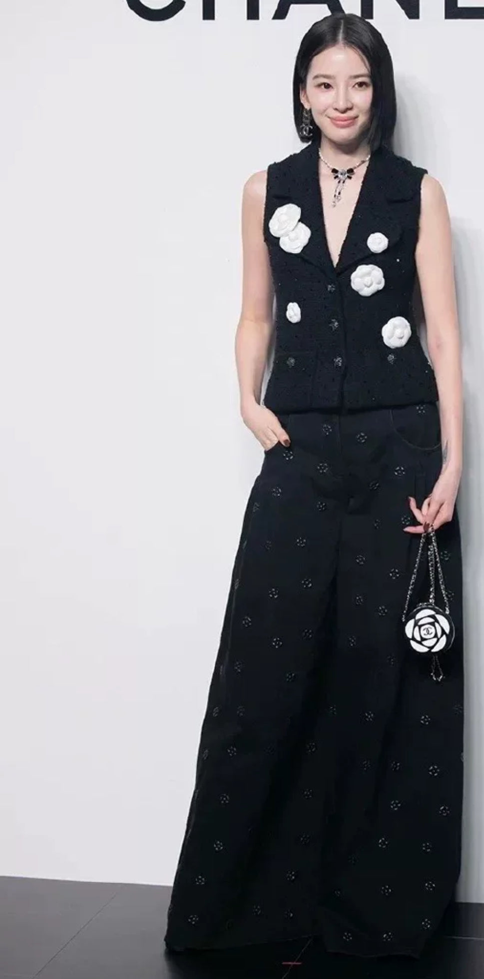 Chanel 23K black camellia wide-leg denim pants