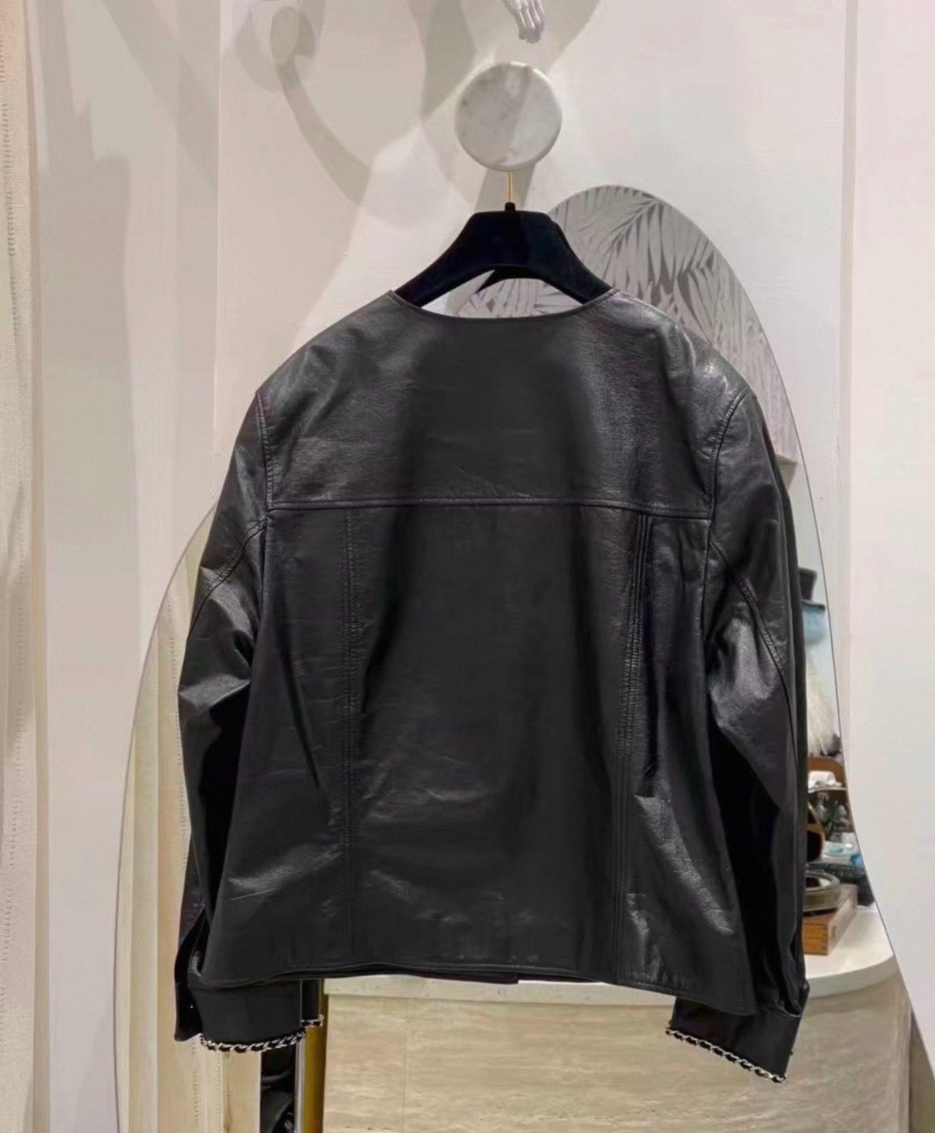 Chanel 24B black leather jacket with chain