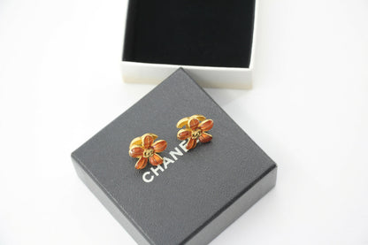 Chanel 03P Enamel Orange Five-Petal Flower Green CC Stacked Earrings