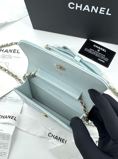 Chanel baby blue quilted leather coin purse with gold chain strap and a bow