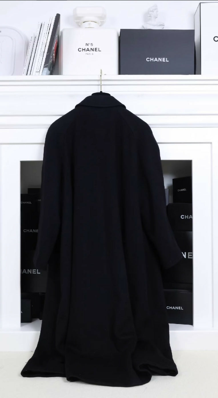 Chanel black woollen coat with black and gold buttons and four pockets.