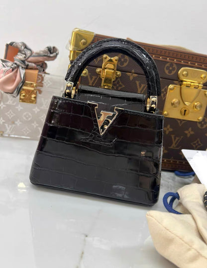 LOUIS VUITTON BLACK MINI CAPUCINES BB HANDBAG IN SHINY CROCODILE LEATHER WITH GOLD HARDWARE