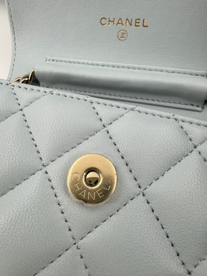 Chanel baby blue quilted leather coin purse with gold chain strap and a bow
