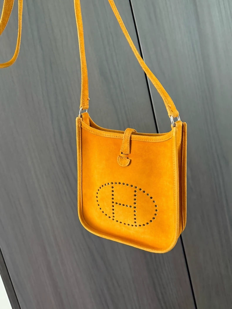 The Hermès Evelyen mini bag in turmeric orange suede is extremely rare!