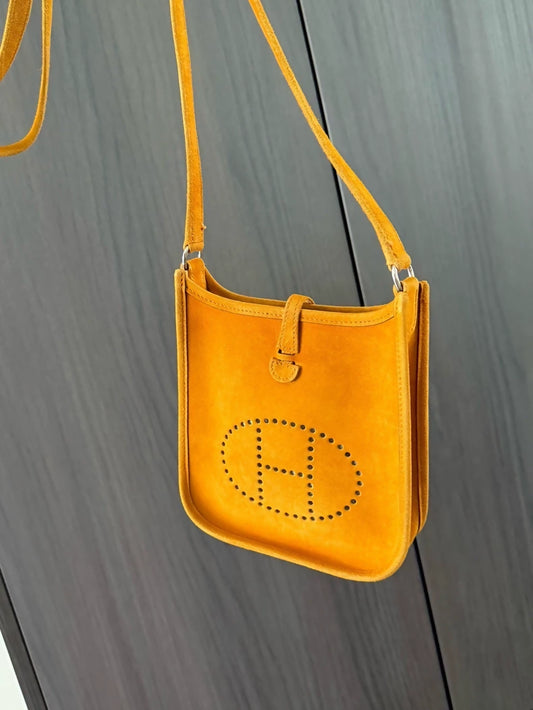 The Hermès Evelyen mini bag in turmeric orange suede is extremely rare!