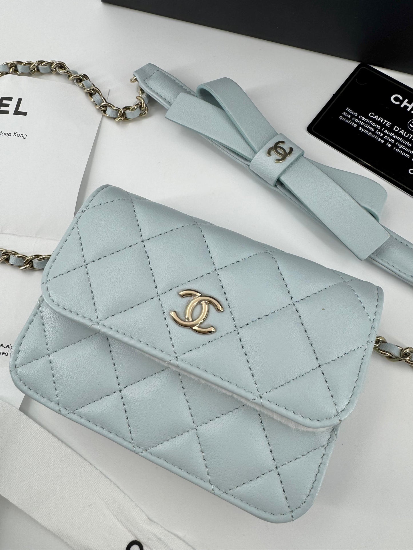 Chanel baby blue quilted leather coin purse with gold chain strap and a bow
