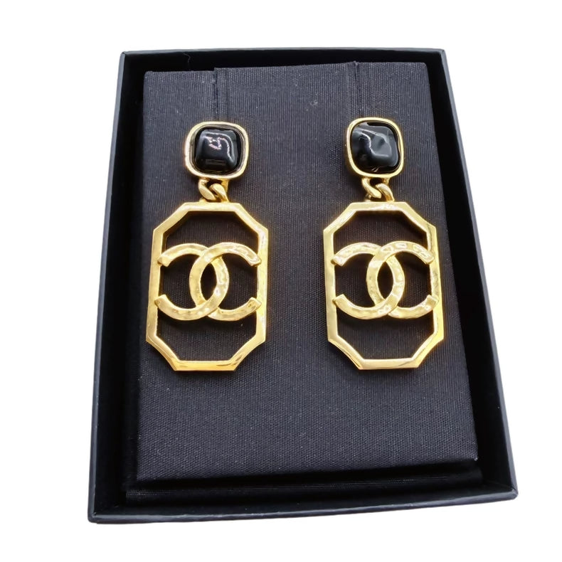 CHANEL black and gold openwork double C pendant earrings