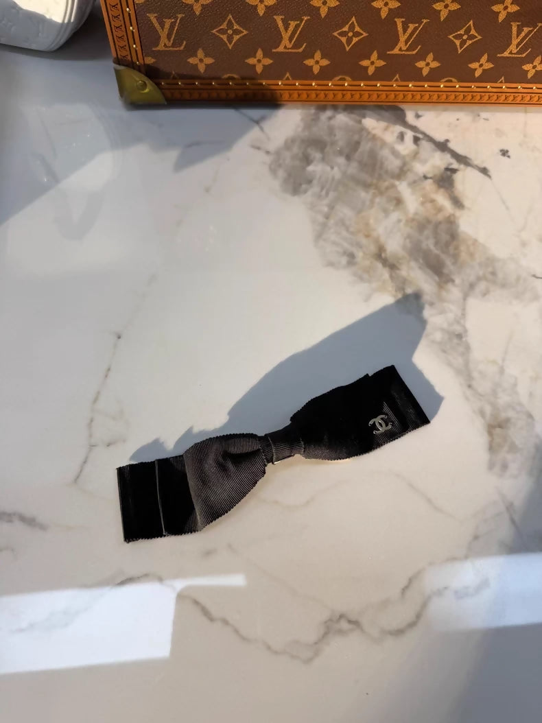 Chanel's classic black bow double-C hair clip