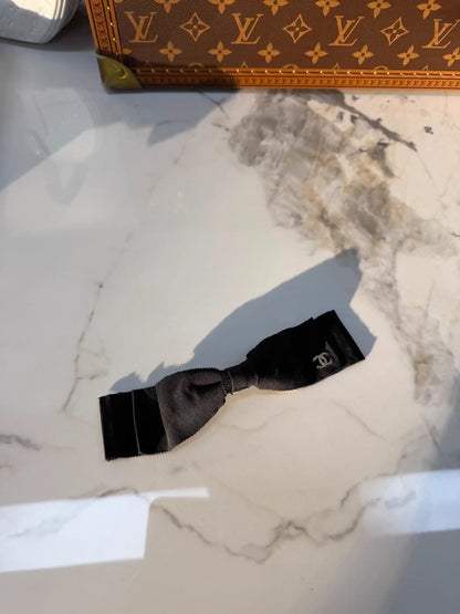 Chanel's classic black bow double-C hair clip