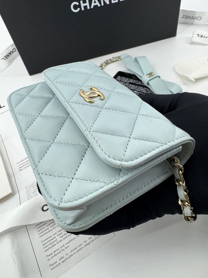Chanel baby blue quilted leather coin purse with gold chain strap and a bow