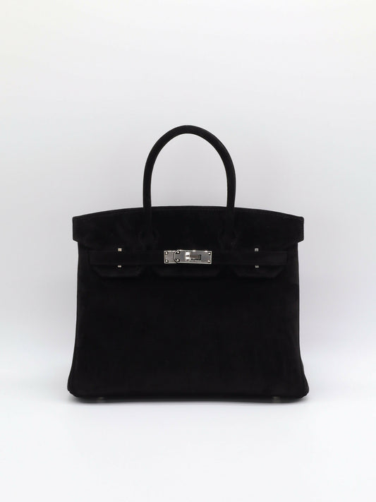 Black suede top-handle handbag with palladium-toned turn-lock clasp and single rolled handle