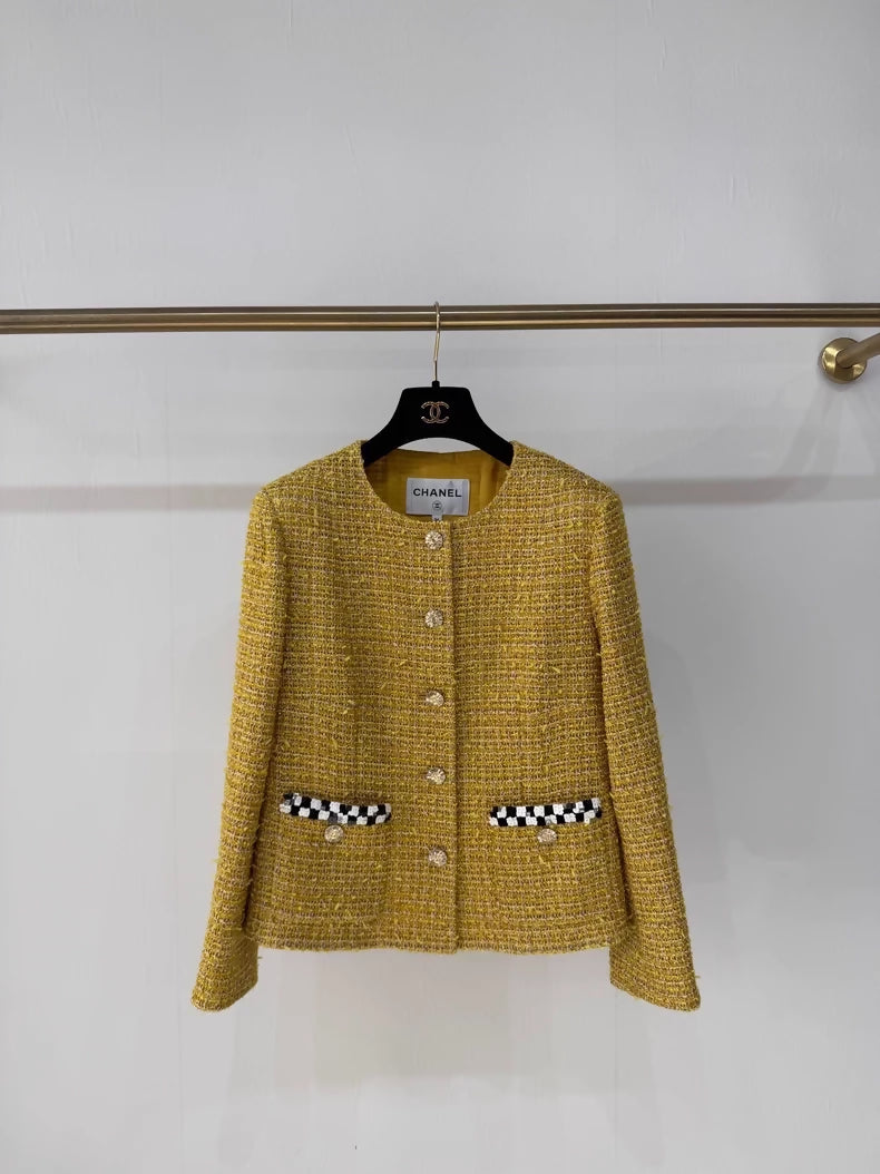 Chanel 23C gold iridescent jacket with black and white checkered sequined pockets and trim