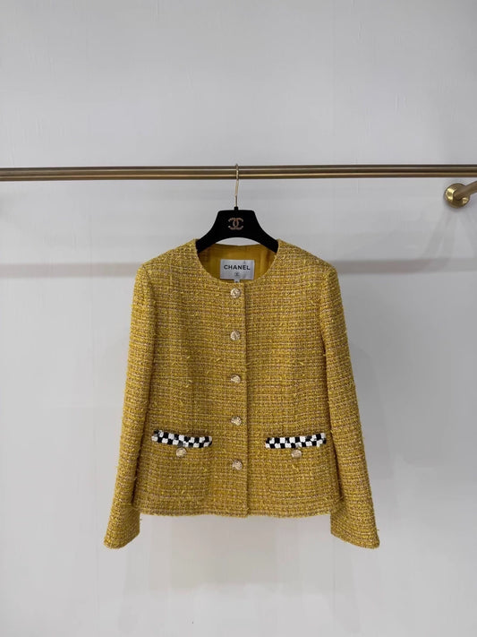 Chanel 23C gold iridescent jacket with black and white checkered sequined pockets and trim