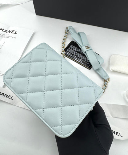 Chanel baby blue quilted leather coin purse with gold chain strap and a bow