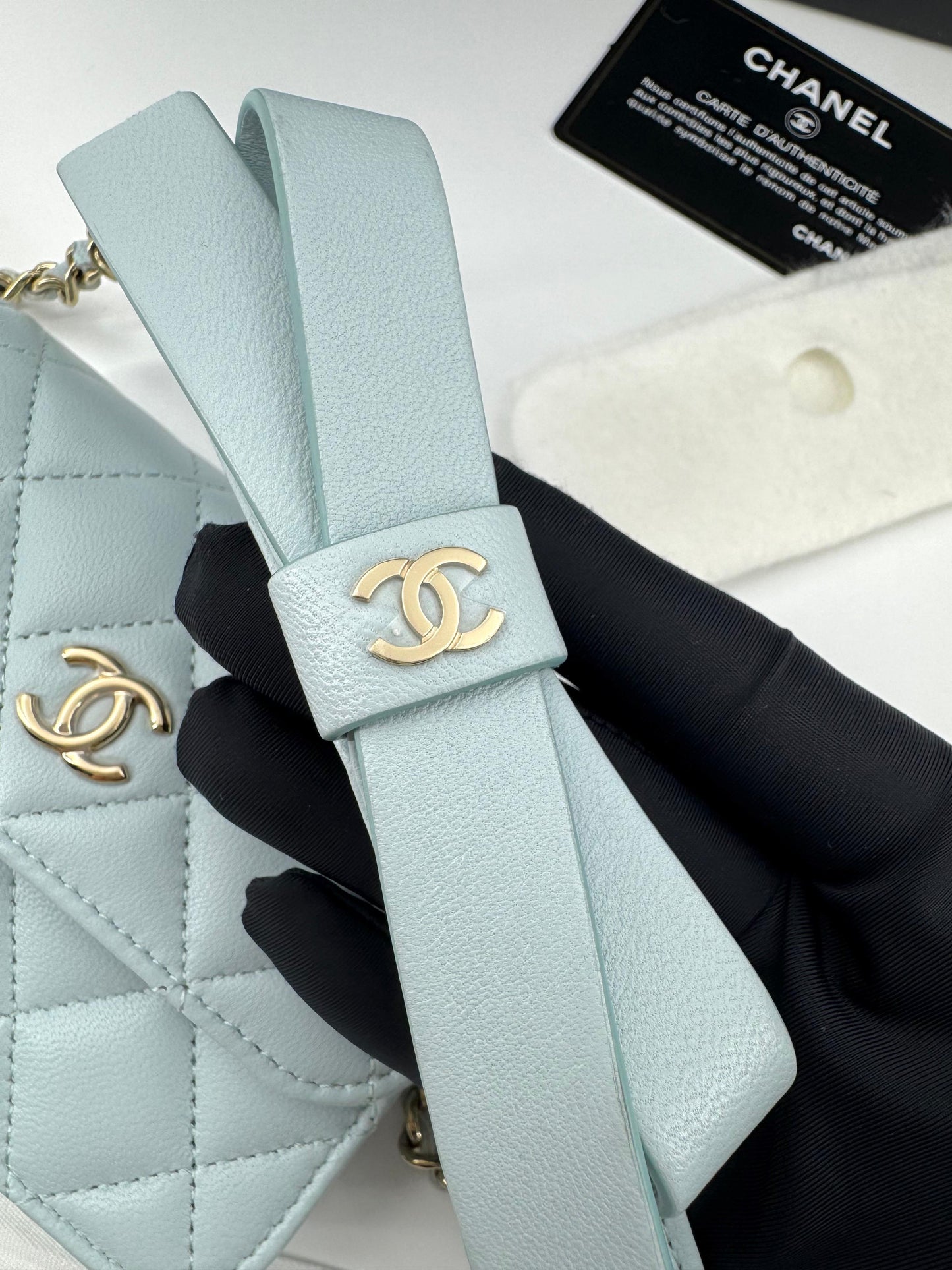 Chanel baby blue quilted leather coin purse with gold chain strap and a bow