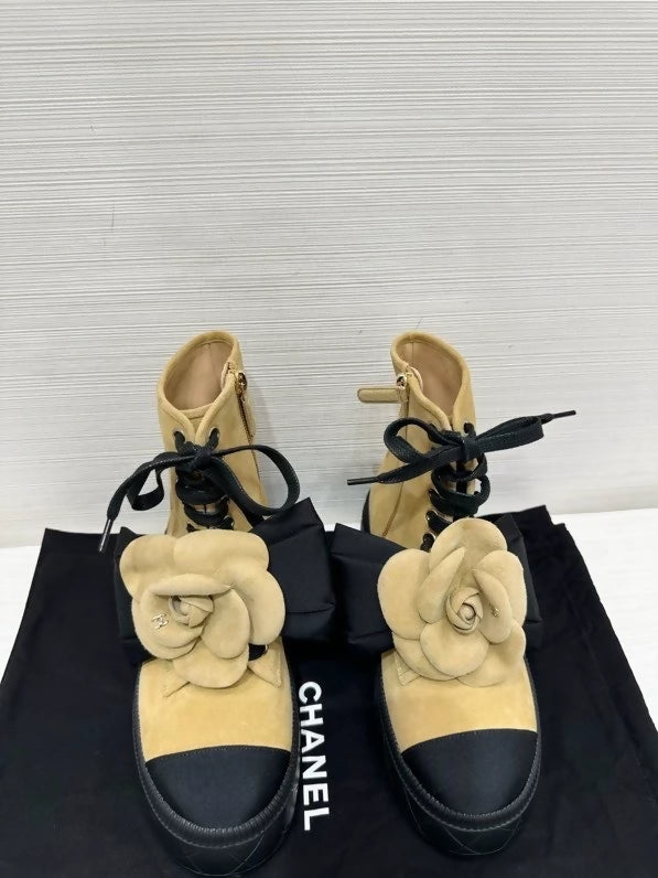 Chanel's popular black and suede camellia ankle boots with bow, size 36.5,