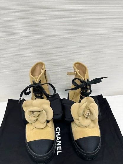 Chanel's popular black and suede camellia ankle boots with bow, size 36.5,