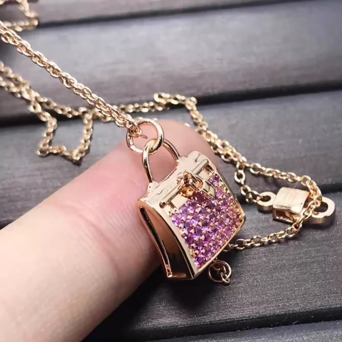Hermès Kelly bag diamond and pink sapphire pendant necklace