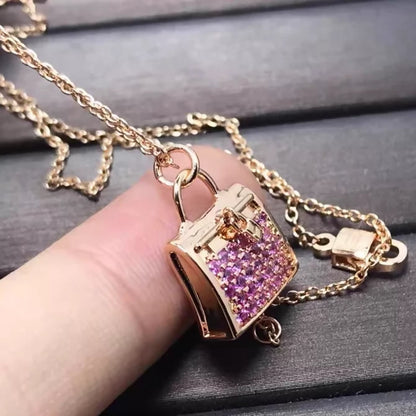 Hermès Kelly bag diamond and pink sapphire pendant necklace