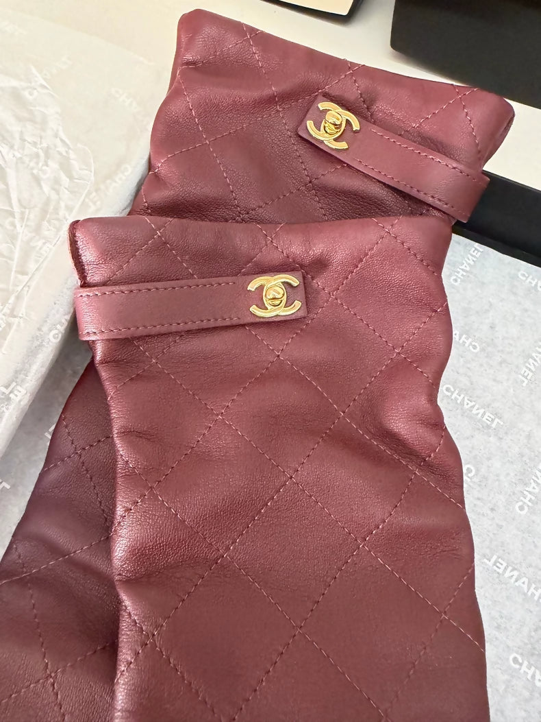 Chanel 26A burgundy backpack with buckle and leather gloves, size 7.5.
