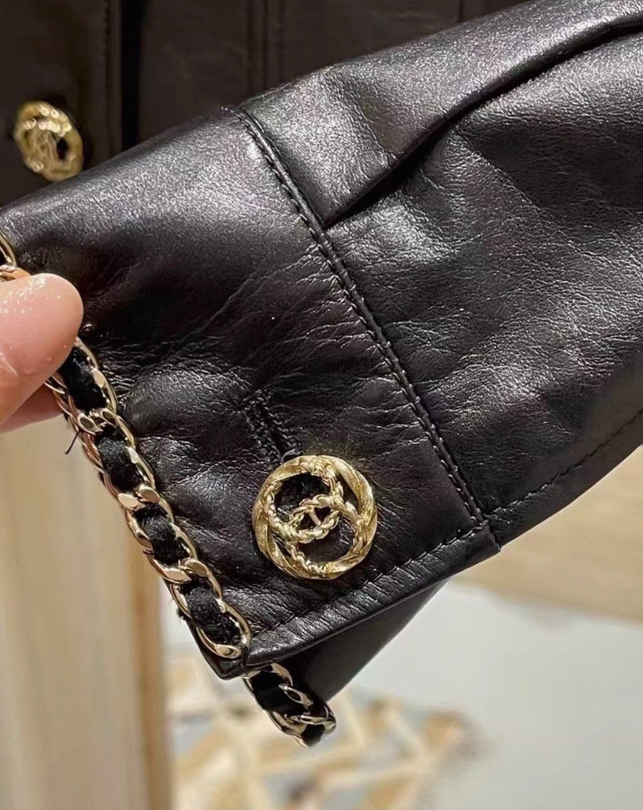 Chanel 24B black leather jacket with chain