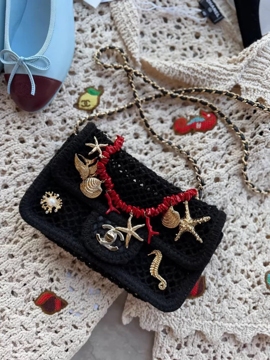 Chanel 26M black knit bag with gold ocean charms and red corals