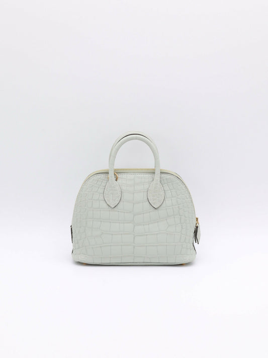 Pale grey crocodile-embossed dome handbag with rolled top handles and gold-tone zip