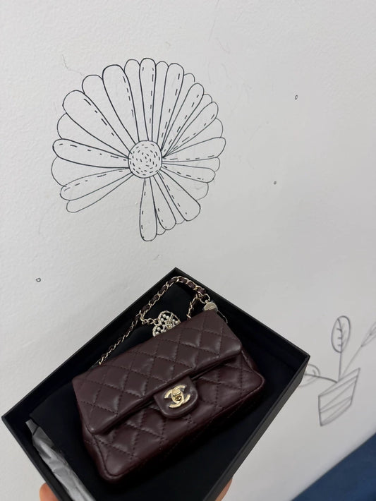 Chanel 25A heart-shaped rhinestone and pearl CF bag key charm.