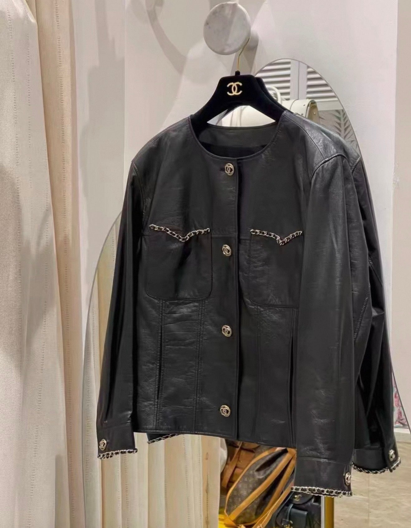 Chanel 24B black leather jacket with chain