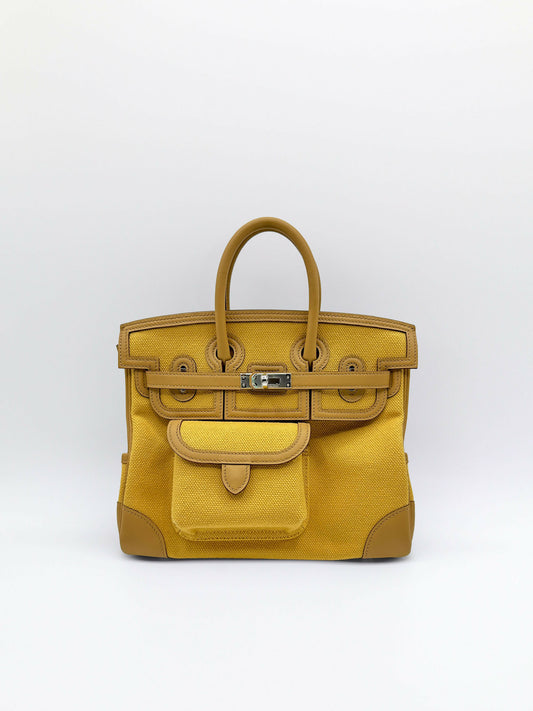 Structured top-handle handbag in mustard yellow woven canvas with tan leather trim, front patch pocket and palladium turn-lock